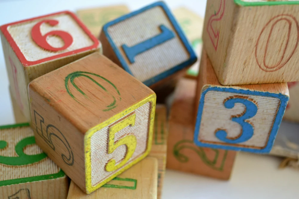 pile of toy Wooden blocks painted with colourful numbers on each side